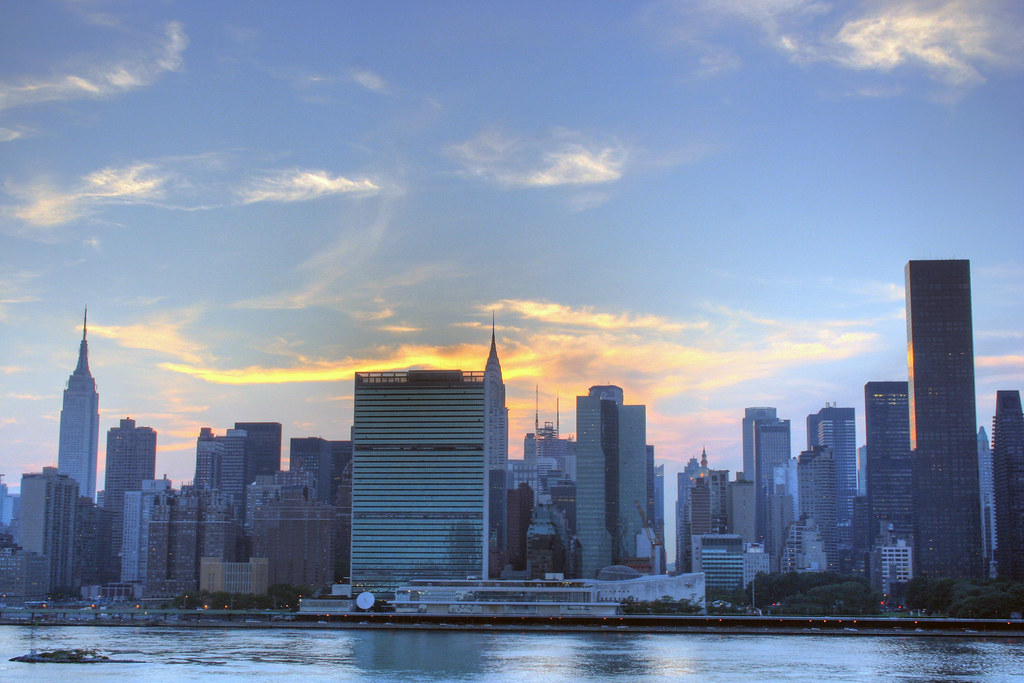 modern city skyline at sunset with reflection on river
